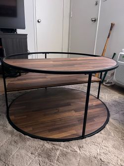 Round coffee table with tiered half-circle shelves. 36" W x 36" D x 18" H