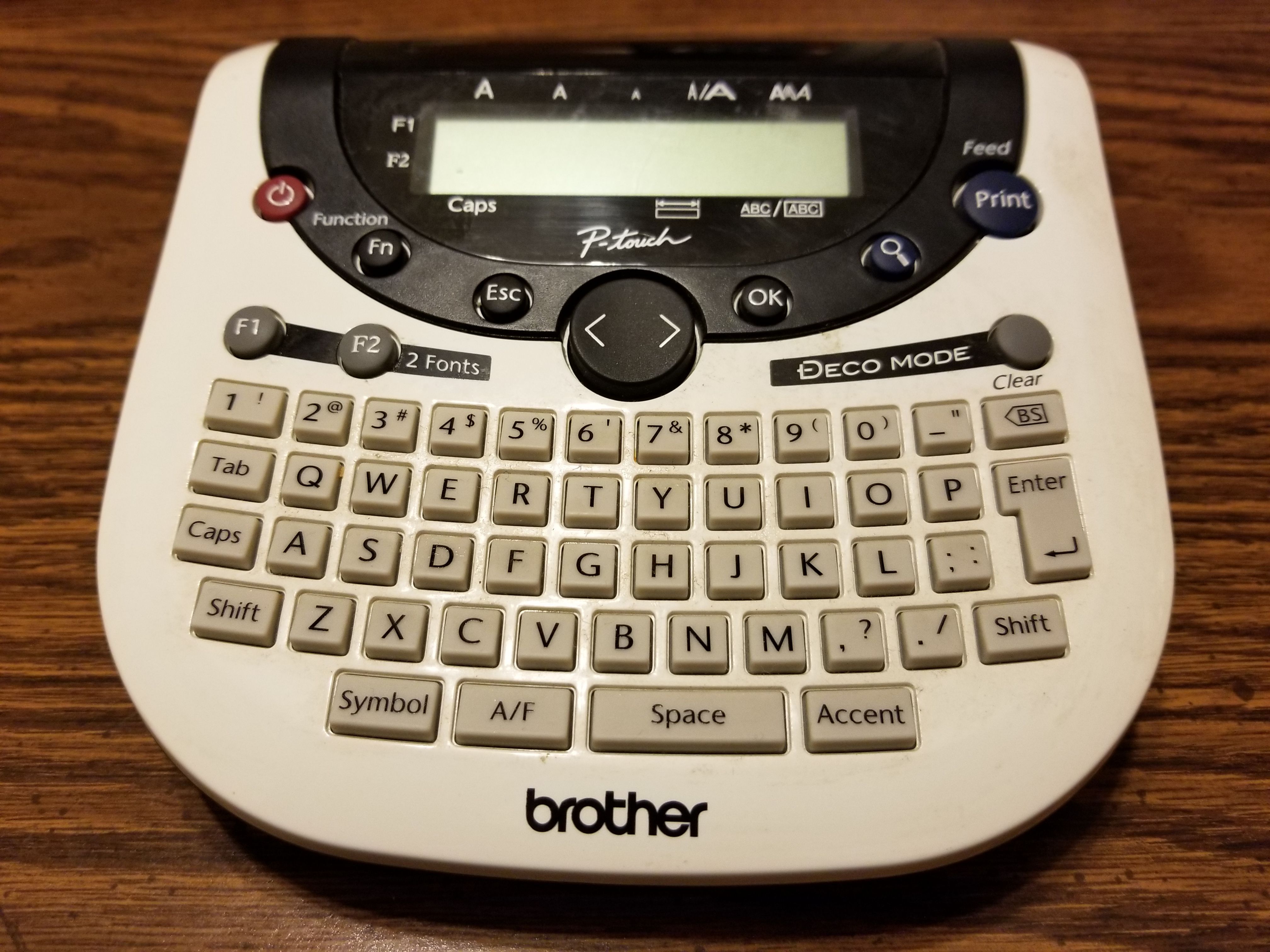 Brother label maker model PT-1290. Takes tape and AAA batteries.