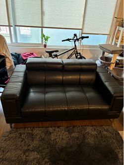 Black leather love seat