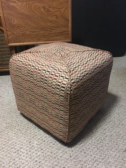 Multi colored (earth tones) box seat or ottoman.