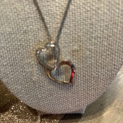 Two Hearts Hanging One Has Crystals One Is Plain In Silvertone