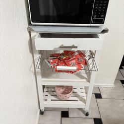 Small microwave with a stand with storage drawers