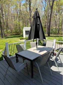 Outdoor rectangular table with 6 chairs and umbrella