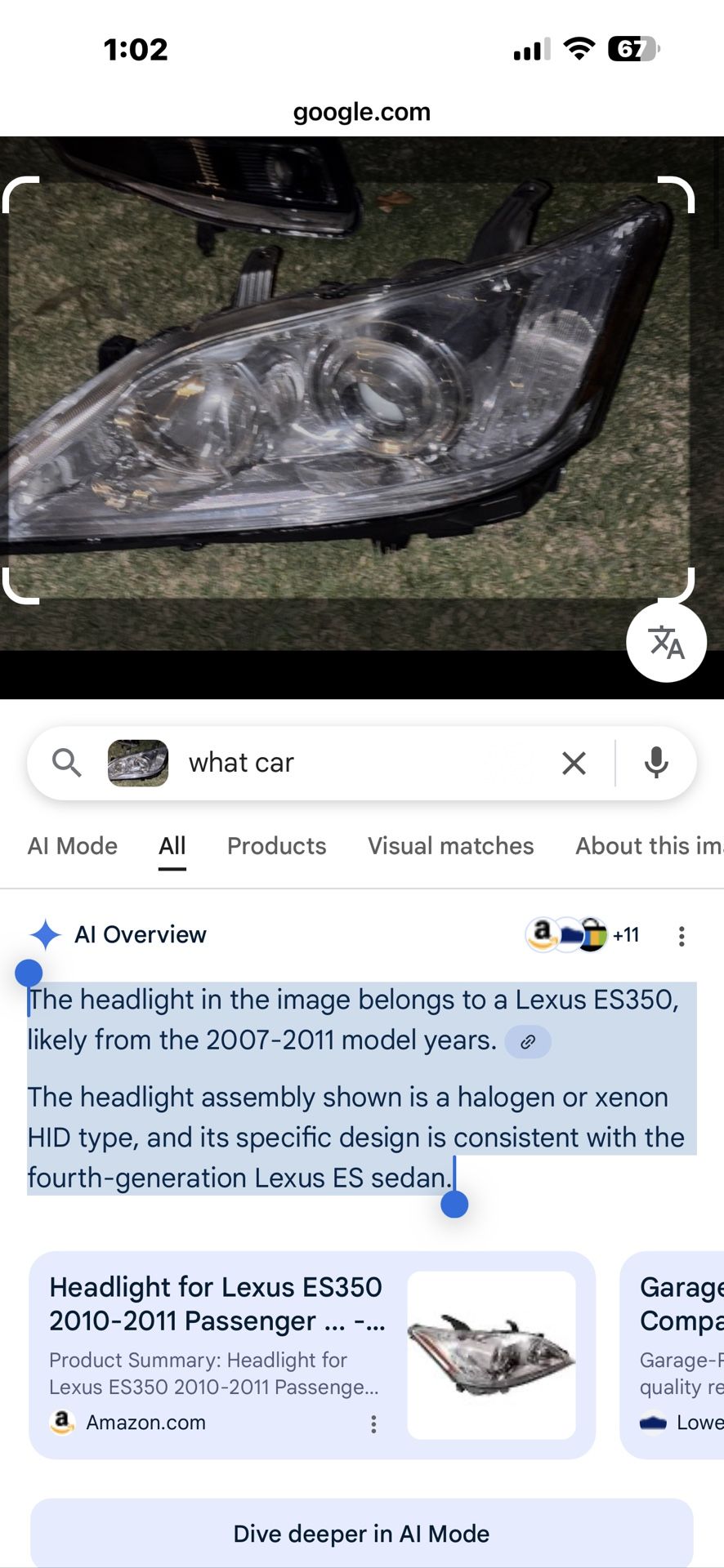 The headlight in the image belongs to a Lexus ES350, likely from the 2007-2011 model years. The headlight assembly shown is a halogen or xenon HID ty