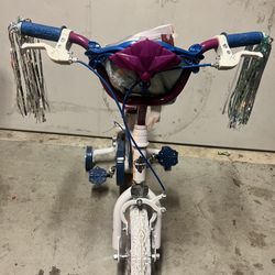 Huffy Frozen 2 - Bicicleta de entrenamiento para niños y niñas de 4 a 8 años, con bolsa para manubrio y serpentinas, color morado