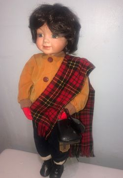 Gorgeous porcelain boy doll holding ice skates