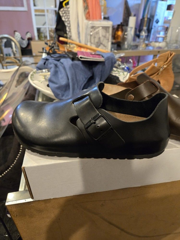 2 Pairs Of Birkenstocks.  One Pair Black, One Pair Brown. 