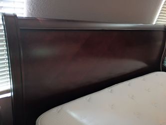 Cherry wood king bed with mattresses.