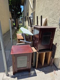 Free furnitures cabinet, end tables, night stand, TV tray table, dining room chairs, iron board, box of children's books.