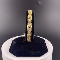 14K GOLD FLOWER DESIGNED BRACELET.