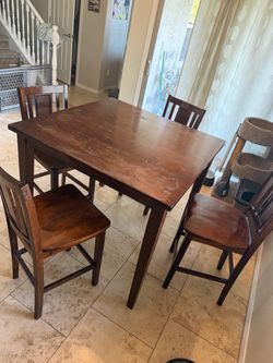 High top table and four chairs High top table and four chairs
