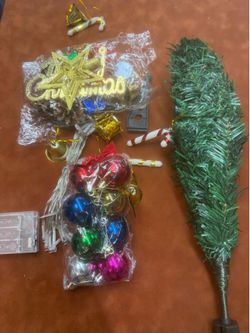 Small Christmas tree with ornaments and decorations as well as lights