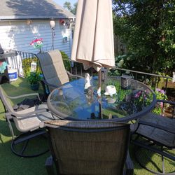 outdoor table with umbrella and 4 chair