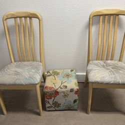 two wooden chairs and an ottoman