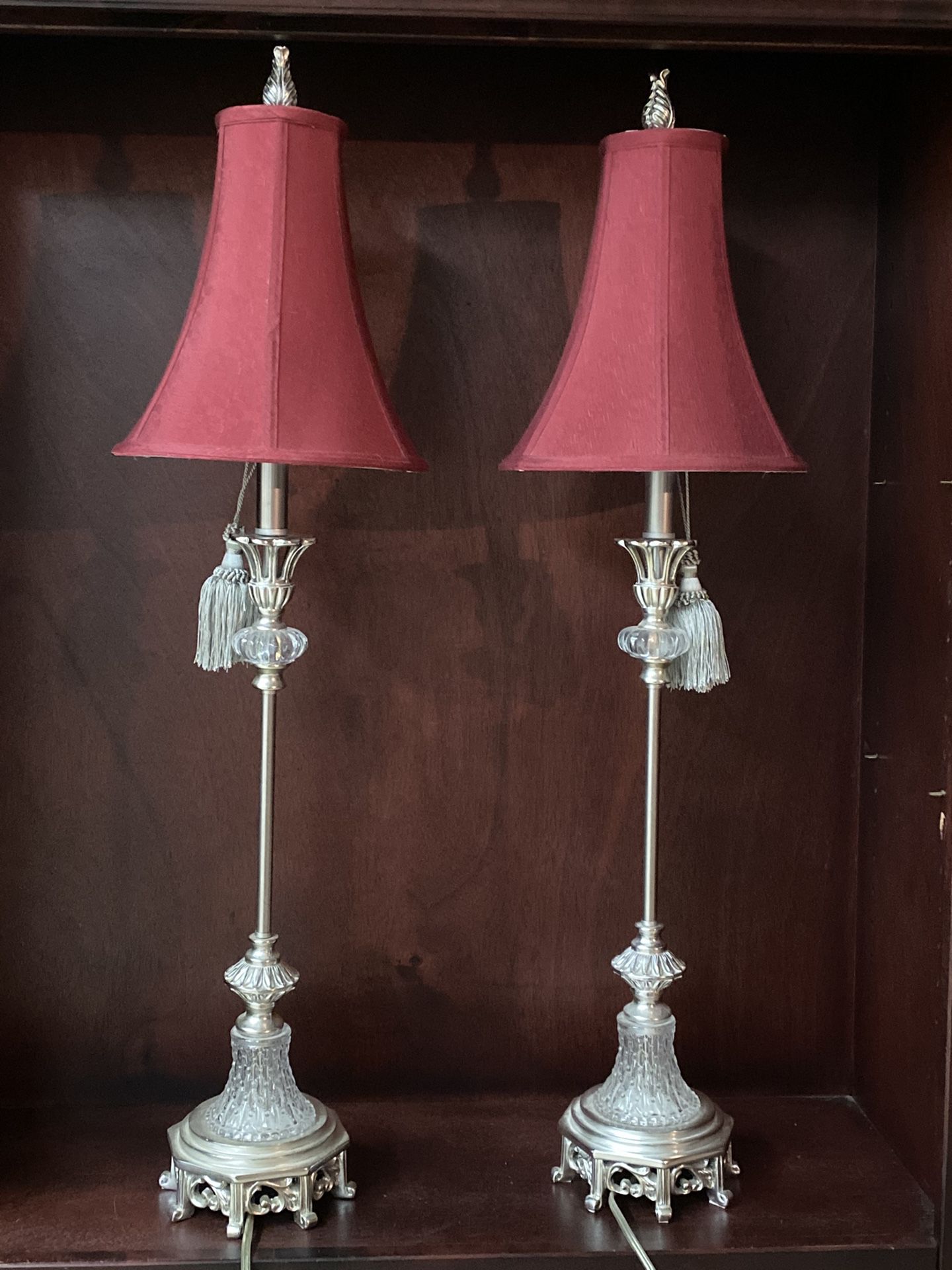 Set of sofa table lamps with maroon shades.