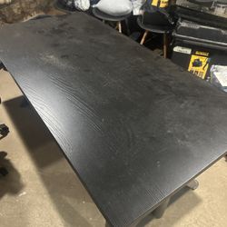 Black adjustable desk and office chair