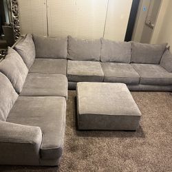 Large gray sectional sofa with ottoman