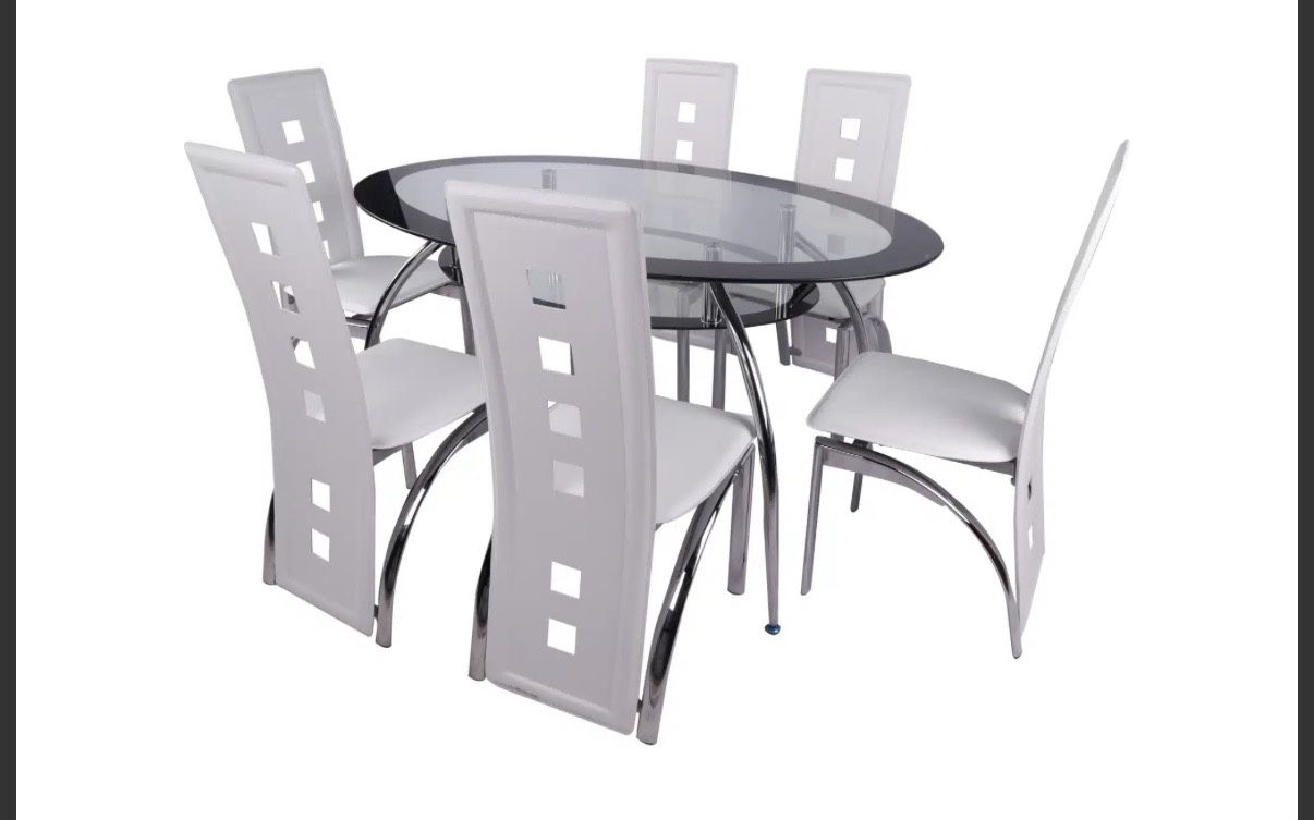 This is a modern dining set featuring a clear oval glass tabletop supported by a chrome-finished base. The set includes six high-back dining chairs wi