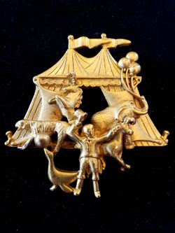 $8. Vintage and unusual circus tent ring leader animal brooch pen marked AJC. Gold tone. Heavy. Measures 2.25 in long and 2.25 in wide.