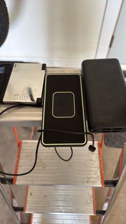Two charging banks and a wireless charging pad Two charging banks and a wireless charging pad