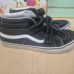 Vans Kids' Sk8-Mid V shoes in black and white featuring hook-and-loop closures. 