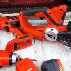 three Black & Decker drills one chainsaw three batteries and charger 