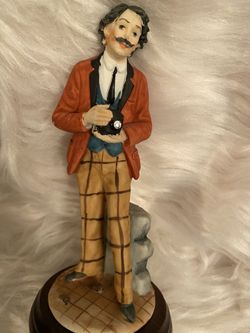 Statue with the guy holding a camera