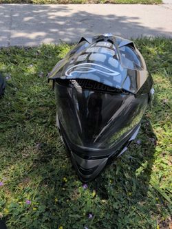black FLY Racing off-road helmet featuring a silver stylized logo on the visor