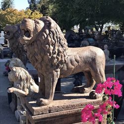 Concrete lion statue with pedestal