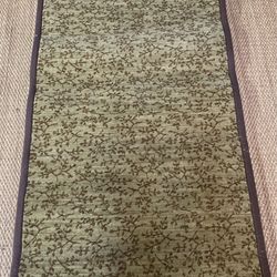 Olive patterned area rug hand bound