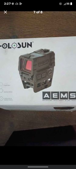 Holosun AEMS (Advanced Enclosed Micro Sight), a compact enclosed reflex optic featuring a wide field-of-view window and multi-reticle system.