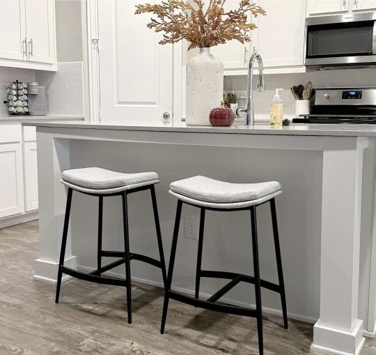 Pair Of Nathan James Arlo Gray Upholstered Counter Height Saddle Bar Stools With Black Metal Base
