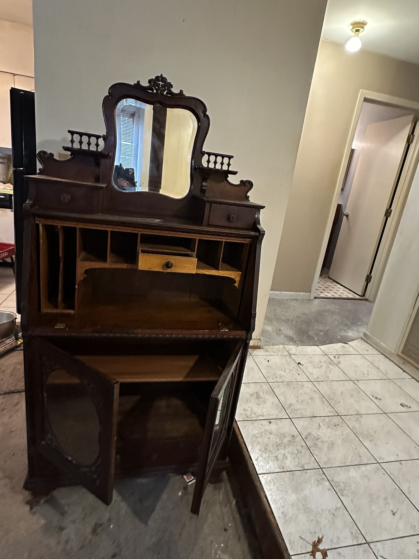 This is an antique mahogany secretary desk with a hutch