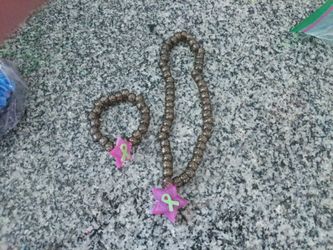 Matching sparkly bead pink epoxy star with green ribbon inside.