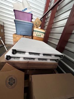 Two white stand up tables