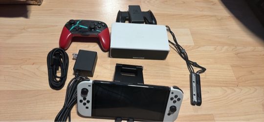 Nintendo switch oled with docking station, joycon grip, controller, wrist straps, charger and hdmi. No trades cash only see my other listings for more