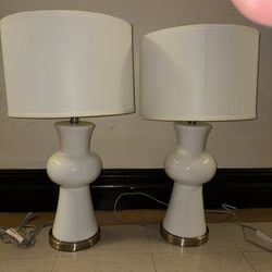 A pair of lamps, never used, practically new. SAFAVIEH Home White Ceramic 28-Incl. Tall Table Lamp in Gloss White - 1 new lamp costs $236.