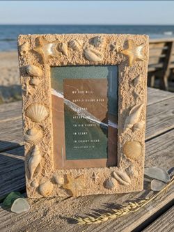 Textured beach picture frame decorated with real seashells and faux-sand finish