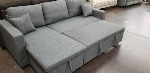 Grey sofa chaise sectional with a pullout bed