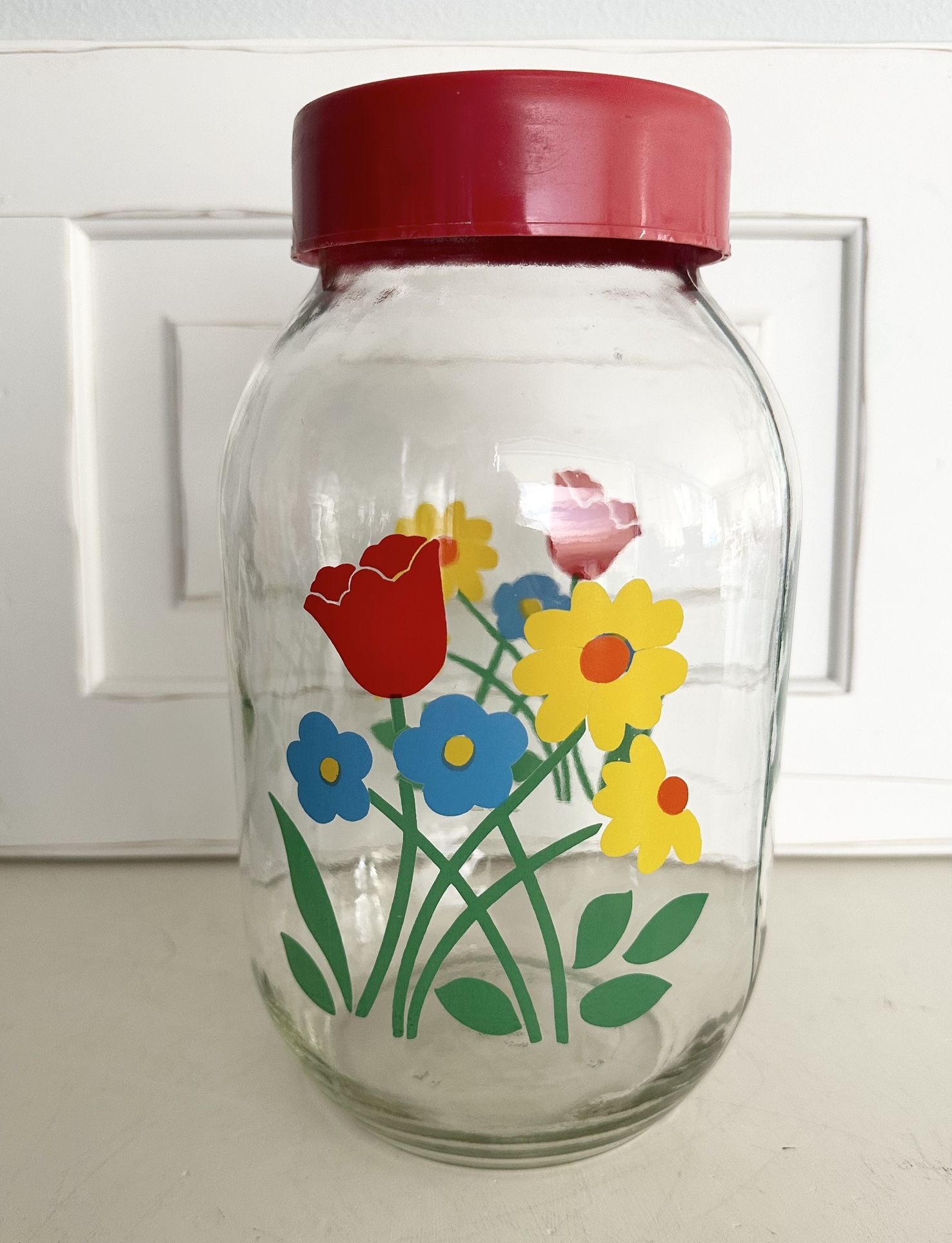 Vintage Carlton Glass Jar / Canister Cute floral bouquet graphics are bright and shiny . Lid is plastic screw on. Great condition. 10 1/2” tall 3liter