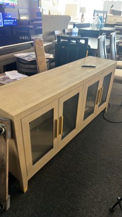 Tv stand 4 door new floor model no space $300. Best offer bring a truck Heavy and great looking