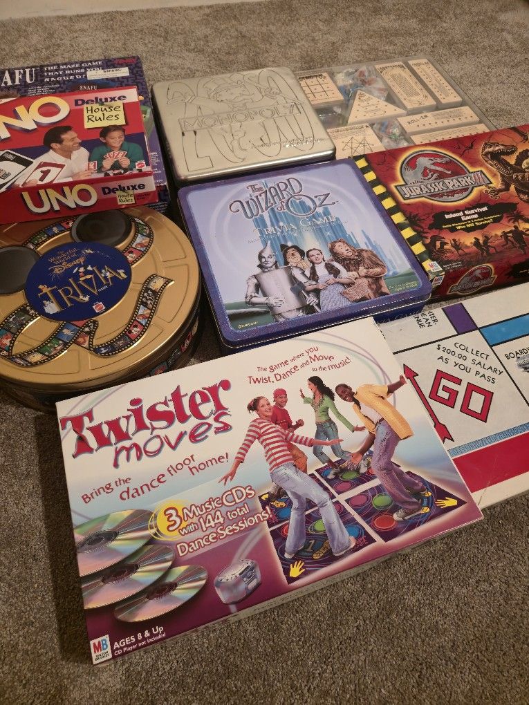 Board Games Lot Twister Moves Wizard of Oz Trivia Board Game Disney Trivia Collectors Tin Uno Deluxe Monopoly 2000 Collectors Tin Jurassic Park SNAFU