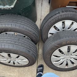 Set of 4 rims and tires 215/60/16 with wheel cups and new tire sensors  tires are 40 % life $275 obo.