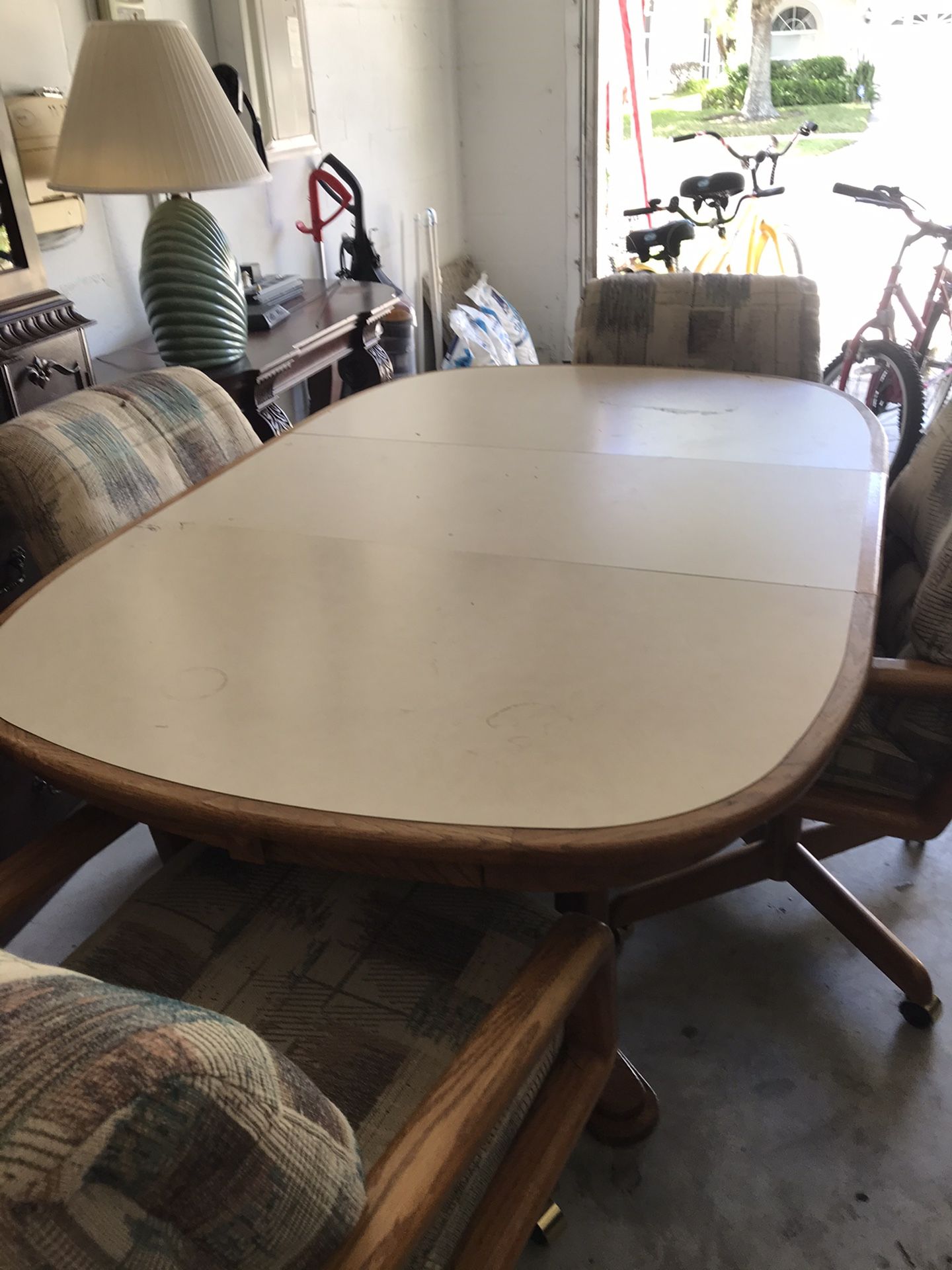 4 chairs with castor wheels and expandable table 65” in length by 42” wide