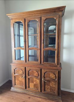 Solid wood China cabinet with interior lights inside.