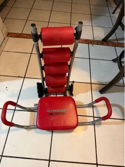 red and silver Ab Rocket Twister abdominal trainer with padded rollers and a rotating