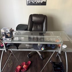 $180 1 year old glass desk 4ft x 25 inches (chair included)