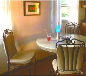Two large heavy wrought iron chairs