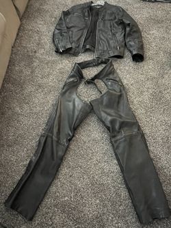 Two Black Leather Jackets, And Three Sets Of Leather Biker Chaps