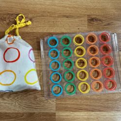 Lovevery Rainbow Connect 4 Toy with bag and dots